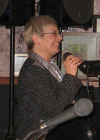 Photograph of Cindee LeVal singing with MHJB